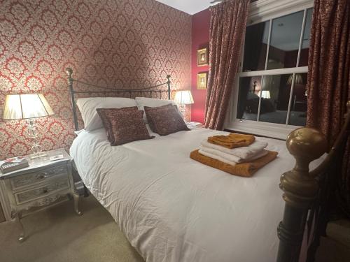 a bedroom with a large bed with a window at Hitchcock House in Hastings