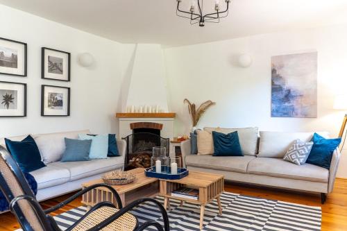a living room with a couch and a coffee table at Willa Hamptons in Huta Podgórna