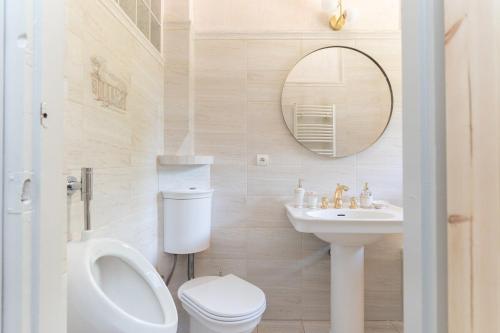a bathroom with a toilet and a sink and a mirror at Willa Hamptons in Huta Podgórna