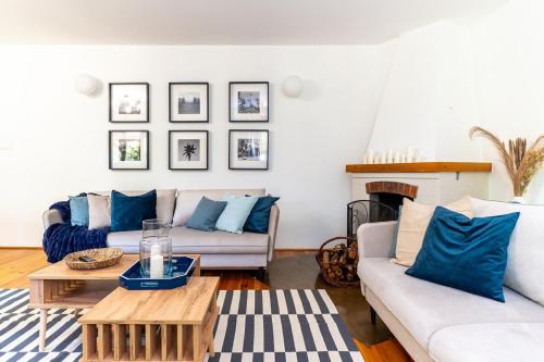 a living room with two couches and a coffee table at Willa Hamptons in Huta Podgórna