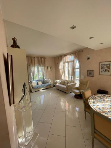 - un grand salon doté d'un grand carrelage blanc dans l'établissement L'azura Villa Front De Mer Golf Juan, à Vallauris