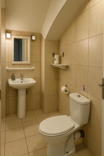 a bathroom with a toilet and a sink at Relax Private Pool House in Maleme
