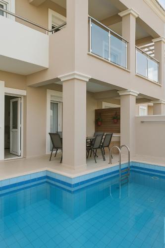 a villa with a swimming pool and a house at Relax Private Pool House in Maleme