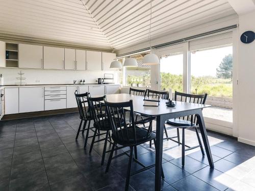 a kitchen and dining room with a table and chairs at Inviting holiday home in Karrebæksminde in Karrebæksminde