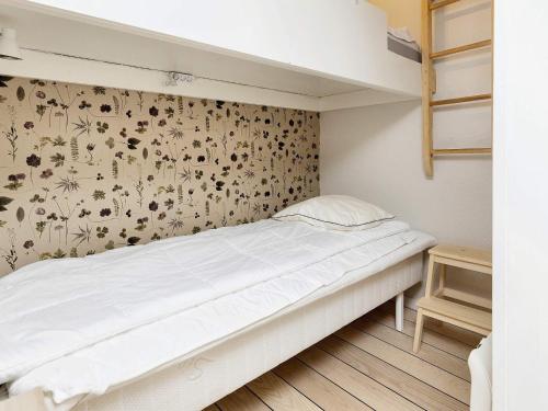 a bedroom with a bed with a flowery wallpaper at Inviting holiday home in Karrebæksminde in Karrebæksminde