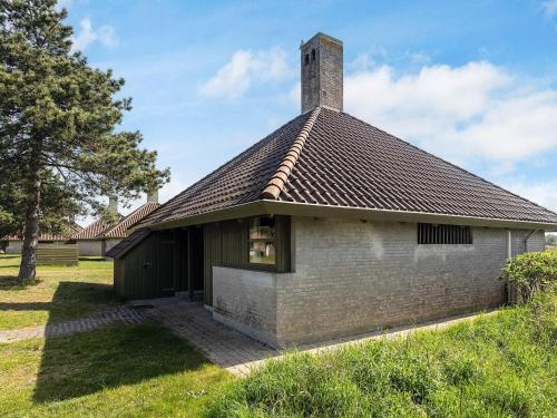 a brick building with a chimney on top of it at Holiday home Karrebæksminde LIII in Karrebæksminde