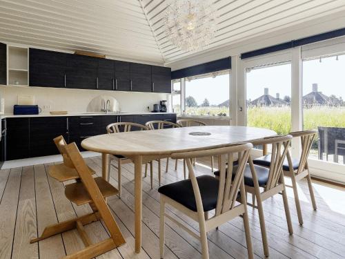 a kitchen with a wooden table and chairs in a room at Holiday home Karrebæksminde LIII in Karrebæksminde
