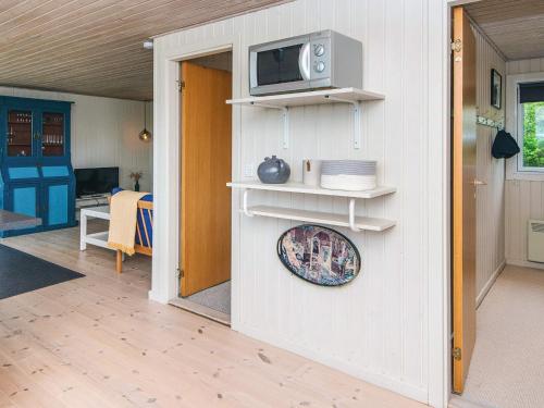 a room with a wall with a microwave on it at 6 person holiday home in Thyholm-By Traum in Thyholm