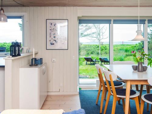 a kitchen and dining room with a table and chairs at 6 person holiday home in Thyholm-By Traum in Thyholm