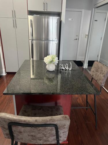 a kitchen with a counter top with a refrigerator at Cozy Ensuite private room homestay in Mississauga