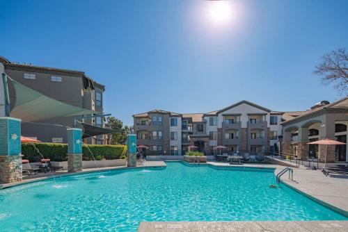 a swimming pool in a apartment complex with buildings at Elegant 1BD King Bed, Pool, Hot Tub, Gym, Parking in Glendale