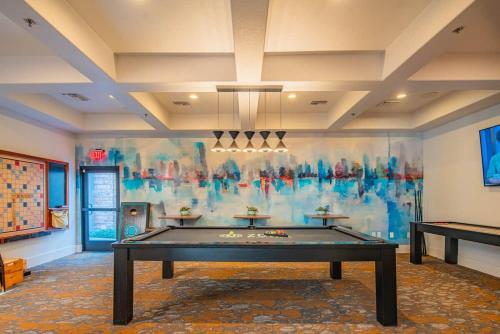 a room with a pool table in front of a wall at Elegant 1BD King Bed, Pool, Hot Tub, Gym, Parking in Glendale
