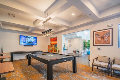 a living room with a ping pong table in it at Relaxed 2BD King Bed Pool, Hot Tub, Gym, Parking in Glendale