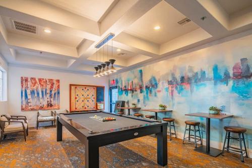 a room with a ping pong table in a room at Chic 2BD King Bed with Pool, Hot Tub, Gym, Parking in Glendale