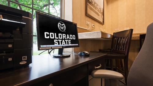 a computer monitor sitting on top of a desk at Best Western University Inn in Fort Collins