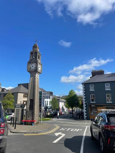a clock tower in the middle of a street at Rolling Hills in Westport