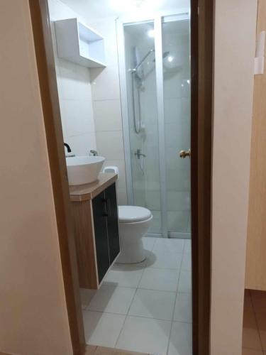 a bathroom with a toilet and a sink and a shower at Blessed Life Homestay in Davao City