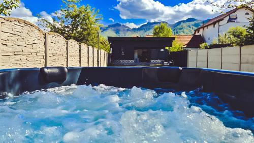 a swimming pool filled with water in a backyard at Alpine Homes in Zărneşti