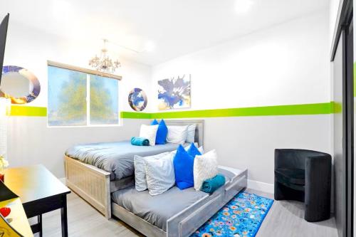 a bedroom with a bed and a couch in it at B - 3BR NoHo Retreat 15m to Universal with Patio, Games & Parking - FIFA World Cup SoFi in North Hollywood