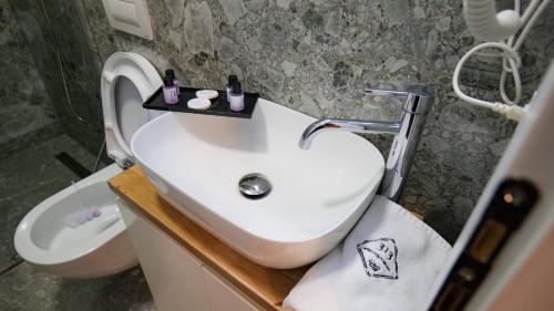 a bathroom with a sink and a toilet at 313 Villa in Tirana