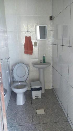 a small bathroom with a toilet and a sink at Sítio Rodrigues in Pedro Leopoldo