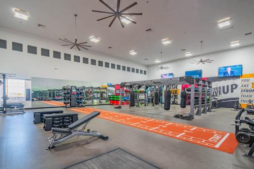 a gym with cardio equipment in a large room at Amiable 2BD King Bed with Pool, Hot Tub, Gym, Parking in Glendale