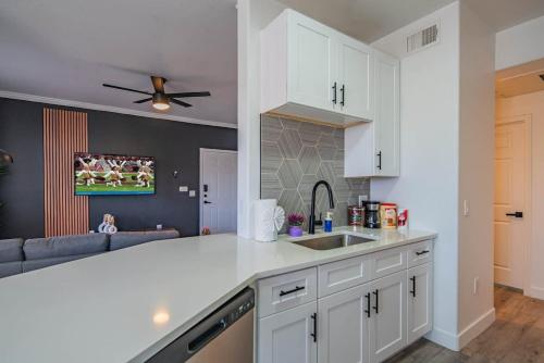 a kitchen with white cabinets and a sink at Amiable 2BD King Bed with Pool, Hot Tub, Gym, Parking in Glendale
