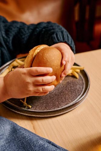 a person holding a sandwich in their hands at Rydges Geelong in Geelong