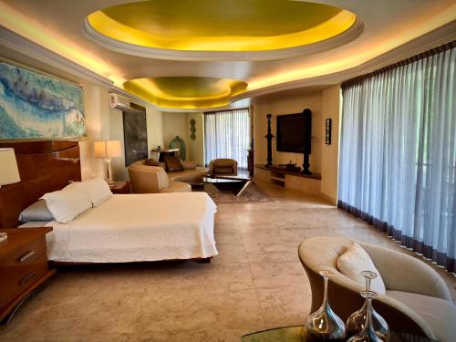 a hotel room with a bed and a yellow ceiling at P V near Colomitos Beach Boutique Hotel in Puerto Vallarta