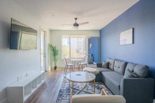 a living room with a couch and a table at Cozy 1BD - Pool, Gym, Parking, W-D - Sleeps 4 in Tempe