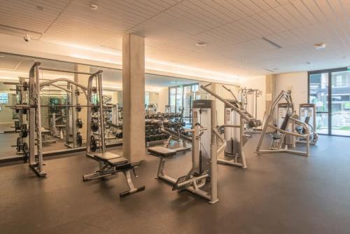 a gym with rows of treadmills and machines at Cozy 1BD - Pool, Gym, Parking, W-D - Sleeps 4 in Tempe