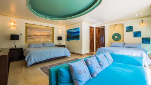 a living room with two beds and a couch at P V near Colomitos Beach Boutique Hotel in Puerto Vallarta