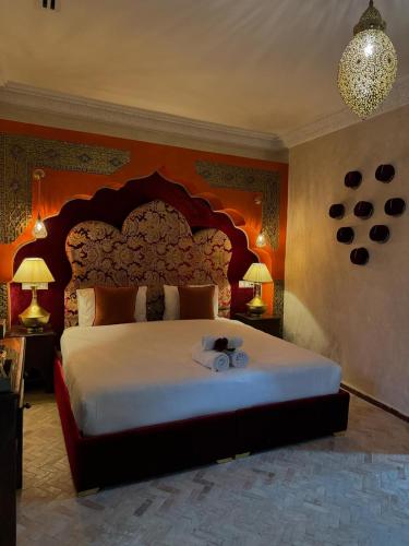 a bedroom with a large bed with a large headboard at Riad M'Barka in Tangier