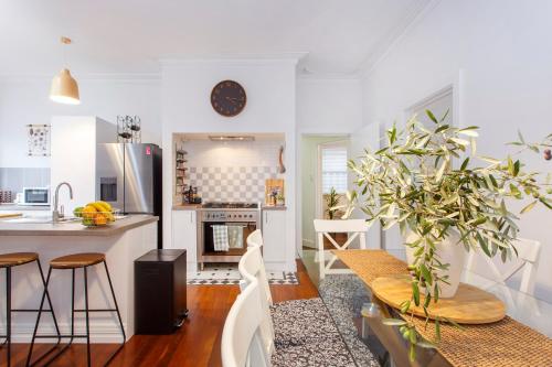 a kitchen and dining room with a table and chairs at Scarborough Coastal Escape in Perth
