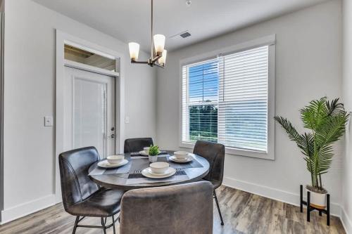 a dining room with a table and chairs at Luxurious King 2BR Suite Mins to Downtown Durham! in Durham