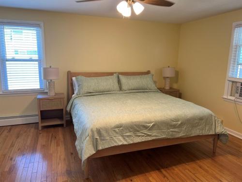 a bedroom with a bed with a ceiling fan at Beautiful Bradley Beach Views, Unbeatable Dream Porch, New Grill, 6 Badges in Bradley Beach