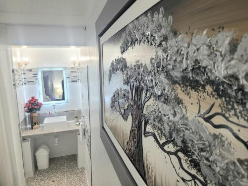 a bathroom with a painting of a tree on the wall at Titicaca lakeside peru in Puno