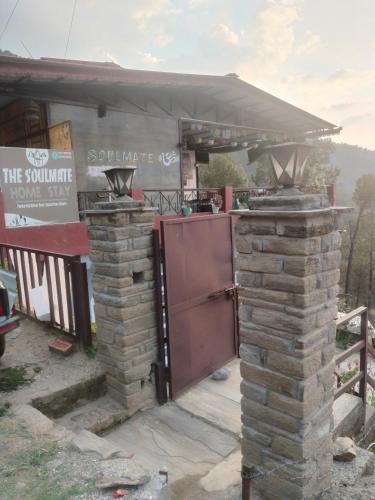 a building with an outdoor kitchen with a stove at Soulmates in Almora