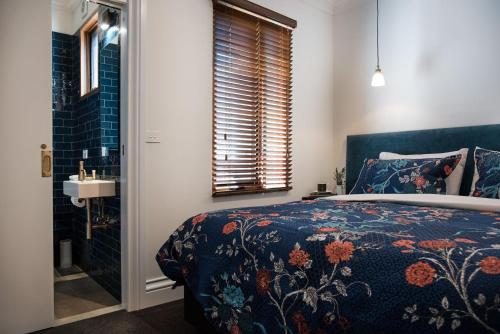 a bedroom with a bed and a bathroom with a shower at Montacute Pavilion and Gardens in Daylesford