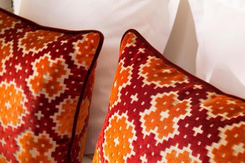 two orange pillows sitting next to each other at Hotel Monge in Paris