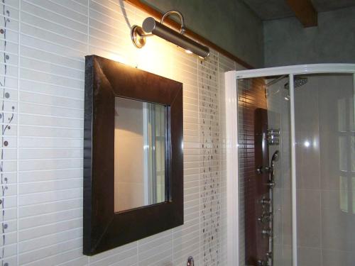 a mirror on the wall of a bathroom at A Casa de Mañas in Mondoñedo