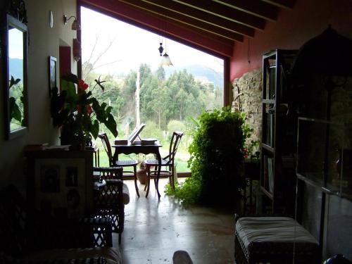 a living room with a large window and a table at A Casa de Mañas in Mondoñedo