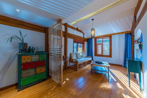 a room with a bedroom with a dresser and a desk at Lijiang half yard hotel in Lijiang