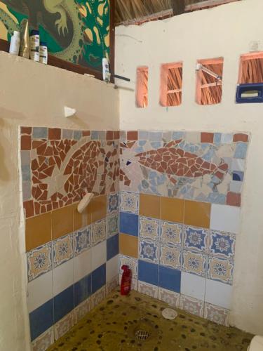 un bagno con piastrelle colorate sul muro di Columpio del Reptil cabaña a Mazunte