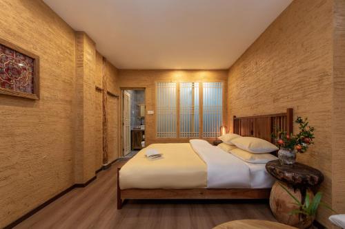 a bedroom with a large bed in a room at Lijiang half yard hotel in Lijiang