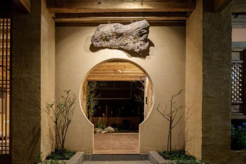 an entrance to a house with an archway at Lijiang half yard hotel in Lijiang