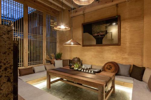 a living room with a couch and a table at Lijiang half yard hotel in Lijiang