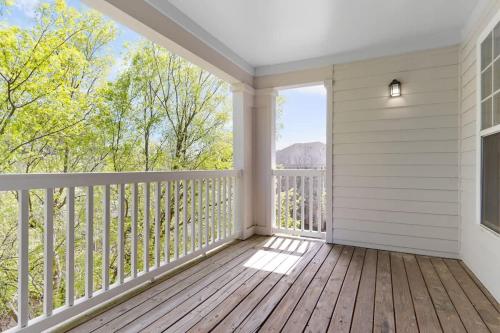 a room with a balcony with a view at Upscale King 2BR Suite Mins to Downtown Raleigh! in Cary