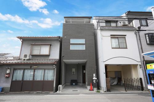 a house with a garage in front of it at 大阪指定特区民泊小田別荘天王寺店OdaVillaTennoji in Osaka