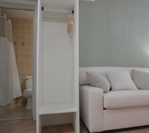 a living room with a white couch and a bathroom at Pier Point in Wildwood
